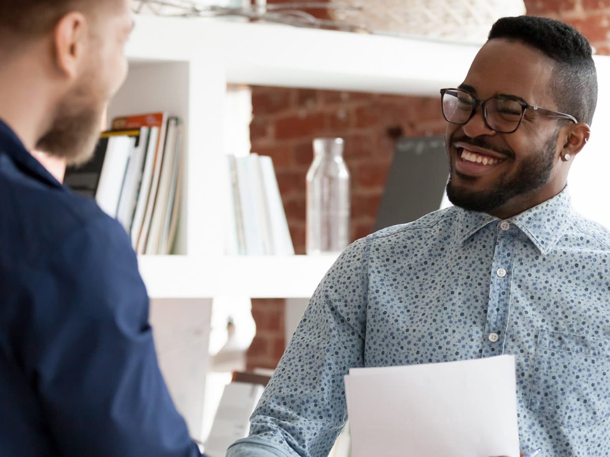 image of two men shaking hands and smiling