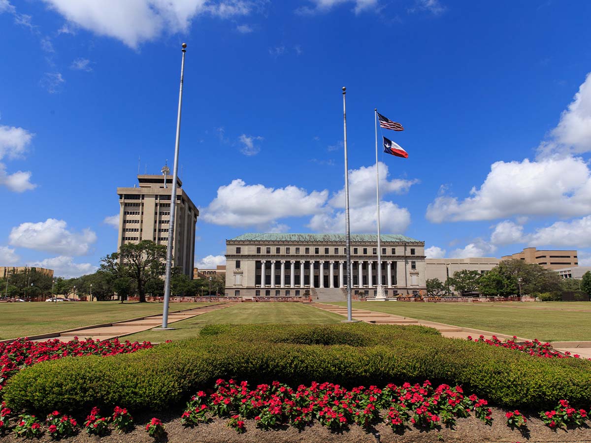 Person sticking a pin into a city map