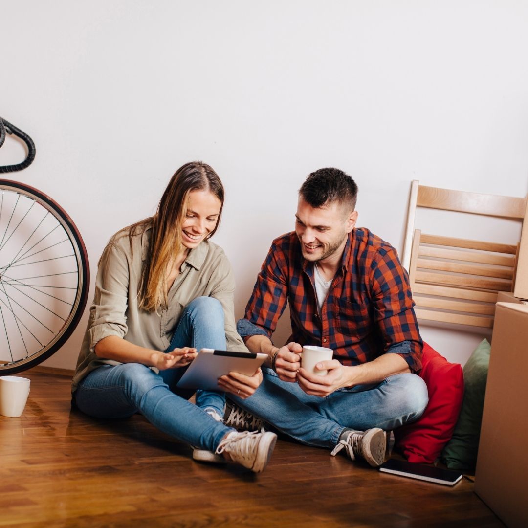 A couple packing boxes and getting ready to move.