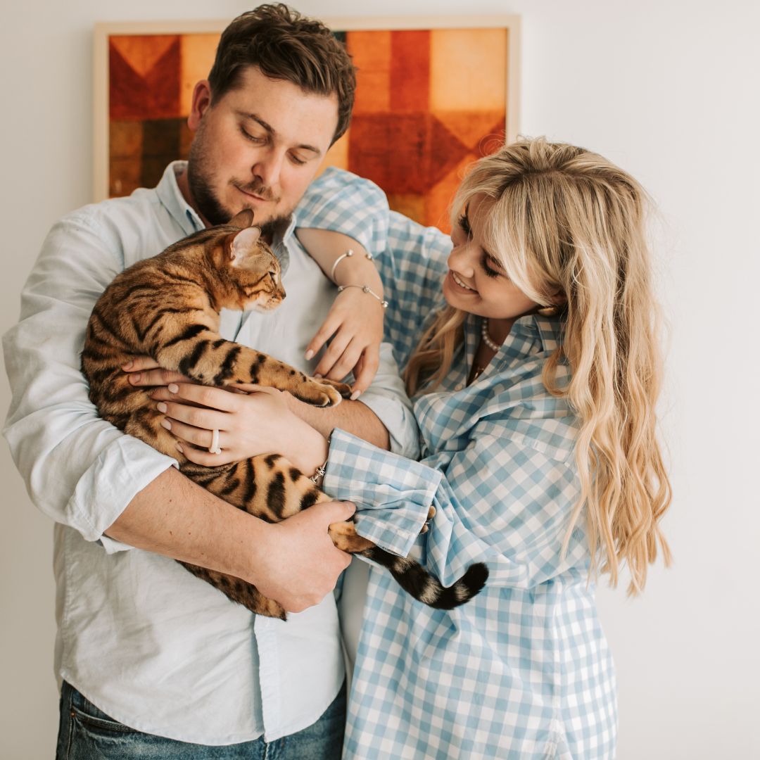 young couple holding cat