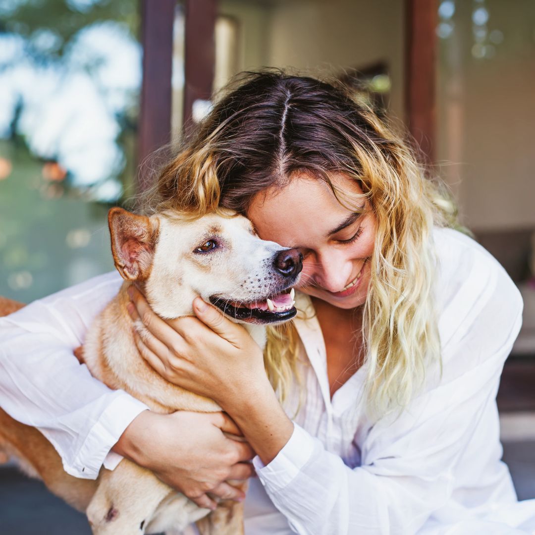 woman hugging dog