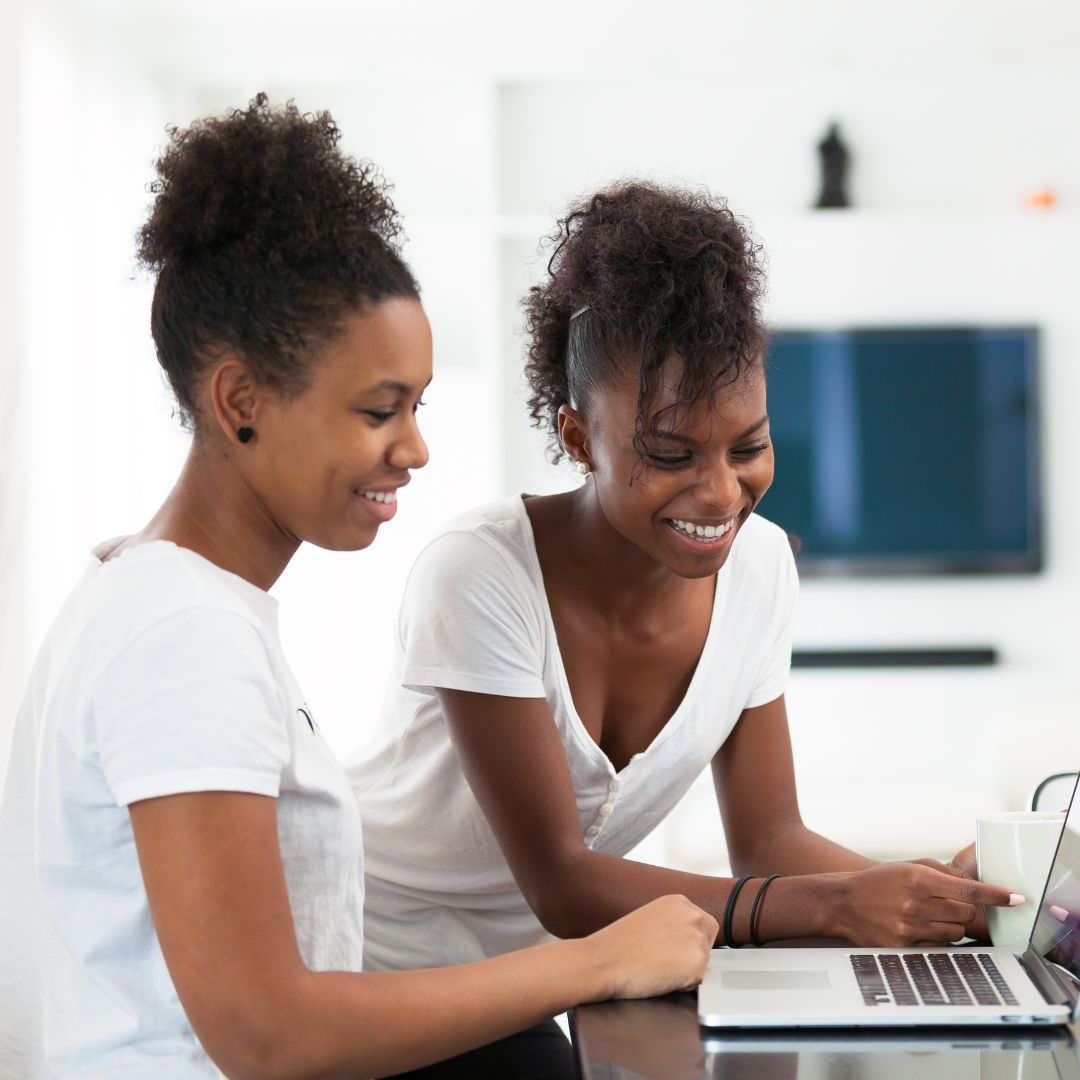 Mother and daughter looking at a laptop