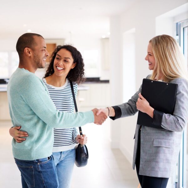 shaking hands with property management employee.