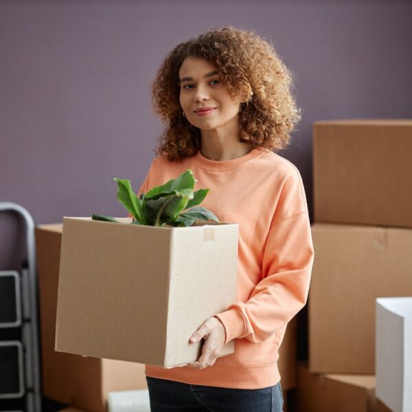 woman carrying packed box
